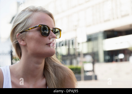 Young woman outside building Stock Photo