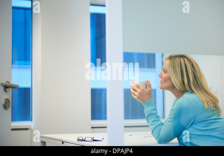 Businesswoman working late at office Stock Photo