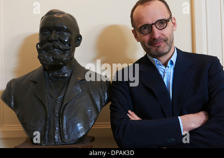 Portrait of confident professional man next to statue Stock Photo