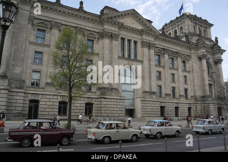 Blue sky view four East German Trabant 601 cars in queue of traffic by Reichstag Building, Scheidemannstrasse, Berlin, Germany Stock Photo