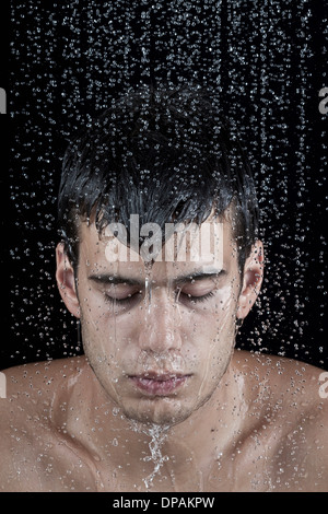 Young man covered with water droplets Stock Photo