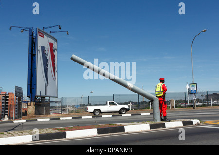 Private security guard standing by a broken lamp post on Queen Elizabeth Bridge. Downtown Johannesburg. South Africa Stock Photo