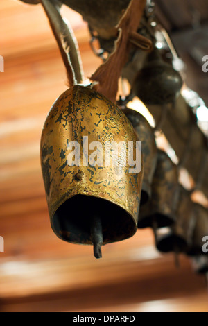Old rural village bell. Old brass village bell for cows. Picture is proper for rural design. Stock Photo