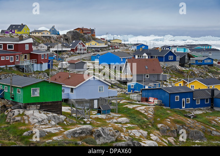 Colorful houses and icebergs in Disko Bay, Ilulissat, West Greenland Stock Photo