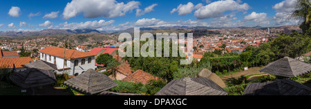 A panoramic view of Sucre, Bolivia from a hilltop showing the red tile roofs and white stucco of the Spanish style architecture. Stock Photo