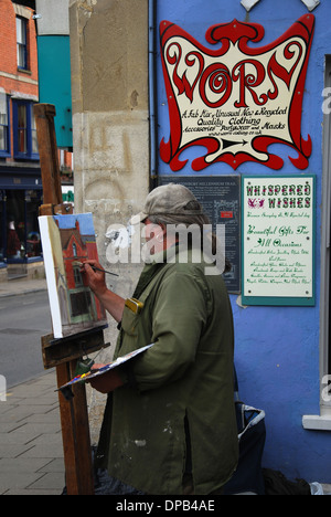 artist in Glastonbury High Street, Somerset UK Stock Photo