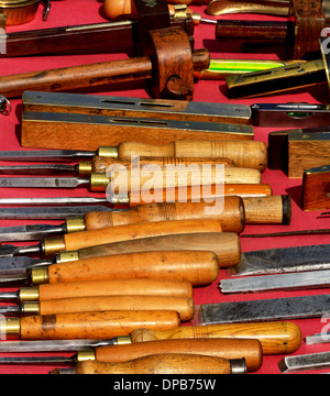 Selection of old used wood working tools displayed on a market stall Stock Photo