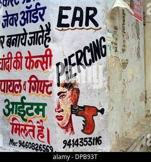 Street advert in Udaipur in Rajasthan in India in South Asia. Small Business Culture Bizarre Surreal Eccentric Travel Wanderlust Stock Photo