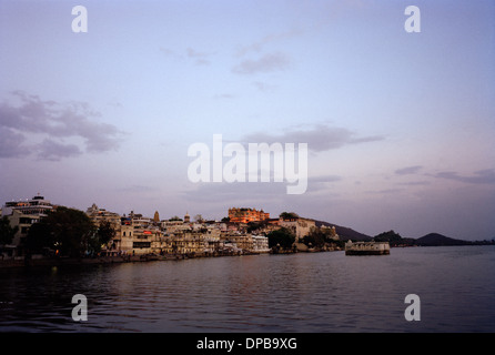 A view across Lake Pichola to the City Palace in Udaipur in Rajasthan in India in South Asia Stock Photo