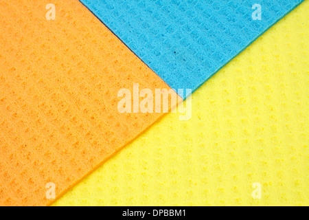 Kitchen towels porous absorbent material in yellow, orange and blue Stock Photo