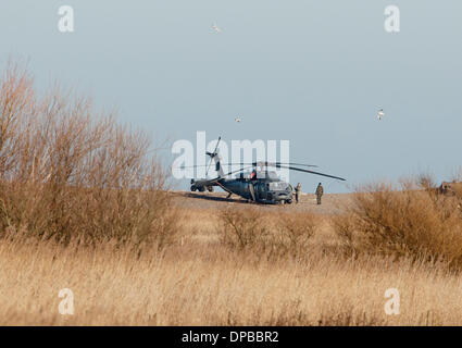 Cley, Norfolk, UK. 11th January 2014. USAF HH-60G Pave Hawk helicopter at  site on the North Norfolk coast at Cley where another crashed leaving four US airmen dead Credit:  Tim James/The Gray Gallery/Alamy Live News Stock Photo