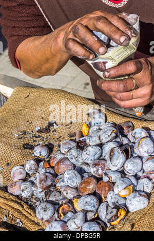 roasted chestnuts are being filled in a bag made of newespaper, aljustrel, alentejo, portugal Stock Photo