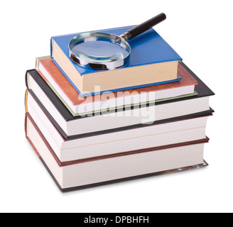 Magnifying glass on stack of books isolated on white Stock Photo
