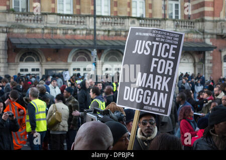 Tottenham, London, UK, 11th Jan, 2014. Relatives and well wishers hold a peaceful vigil for Mark Duggan outside Tottenham police station. The death of Mark Duggan, who was shot on 4 August 2011 by police marksmen, sparked widespread rioting in Tottenham and England. On 8th January 2014 a jury found that his shooting was lawful, which his family and friends still contest. Credit:  Patricia Phillips/Alamy Live News Stock Photo