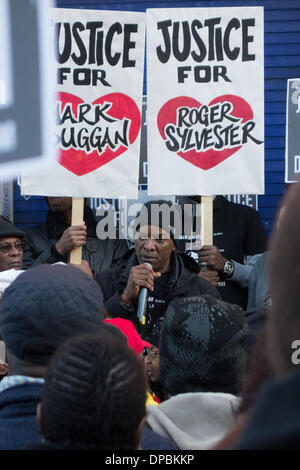 Tottenham, London, UK, 11th Jan, 2014. Relatives and well wishers hold a peaceful vigil for Mark Duggan outside Tottenham police station. The death of Mark Duggan, who was shot on 4 August 2011 by police marksmen, sparked widespread rioting in Tottenham and England. On 8th January 2014 a jury found that his shooting was lawful, which his family and friends still contest. Credit:  Patricia Phillips/Alamy Live News Stock Photo