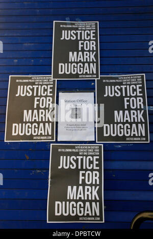 Tottenham, London, UK. 11th January 2014. Posters that read 'Justice for Mark Duggan on the door of Tottenham police station Stock Photo