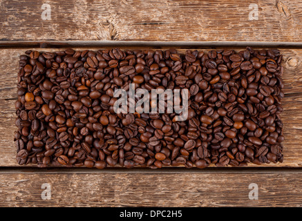 Rectangular shaped of coffee beans on wooden table Stock Photo