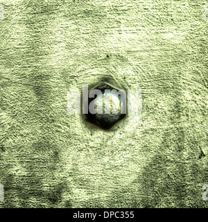 Closeup of grunge green metal plate with rivet screw as background or texture. Square format. Stock Photo