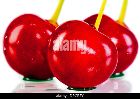 three cherries closeup with water droplets Stock Photo