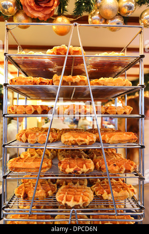 Many waffles for sale on a shelf. nobody, vertical. Stock Photo