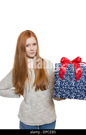Young well dressed red haired Girl presents present with a big smile Stock Photo