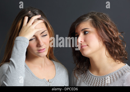 Woman worried and another one comforting her on a dark background Stock Photo