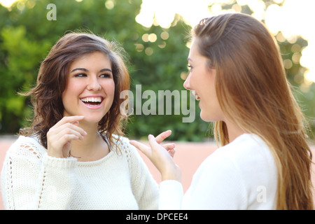 Two young women talking happy outdoor Stock Photo