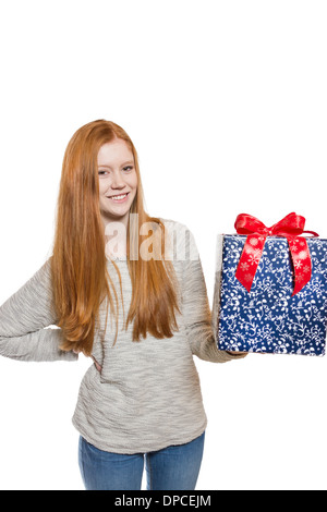 Young well dressed red haired Girl presents present with a big smile Stock Photo