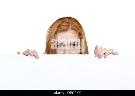 Cute teen girl holding a white sign Stock Photo