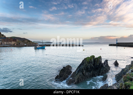 Boat and lighthouse in the harbour at Mevagissey a fishing port on the south coast of Cornwall Stock Photo