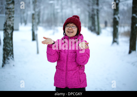 Young and happy asian girl with a pink jacket enjoys snowing Stock Photo