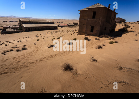 Abandoned buildings in Ghost town in Namibia desert, formerly a mining town named Kolmanskop Stock Photo