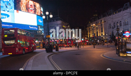 London Piccadilly circus at night with red buses and london cabs from oxford street with tourist and night life Stock Photo