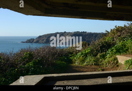 View from inside La Moye Battery, a WW2 gun battery, overlooking Moulin Huet Bay and Saints Bay in Guernsey, Channel Islands. Stock Photo