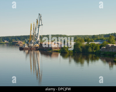 Common sight when traveling the Volga Baltic waterway Russia,forestry activity stacking and transportation of timber Stock Photo