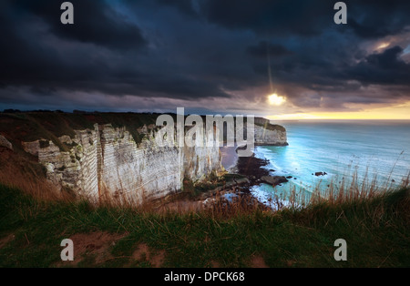 sunshine and storm sky over cliffs in ocean, Etretat, France Stock Photo