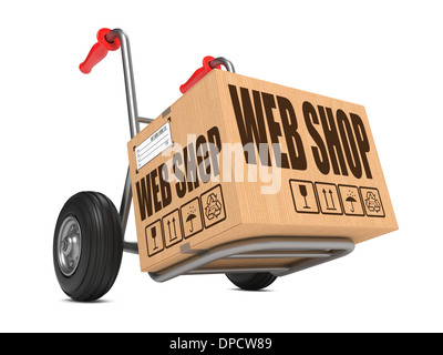 Cardboard Box with Web Shop Slogan on Hand Truck White Background. Stock Photo