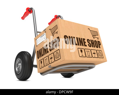 Cardboard Box with Online Shop Slogan on Hand Truck White Background. Stock Photo