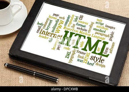 html (hypertext markup language) word cloud on a digital tablet with a cup of coffee Stock Photo