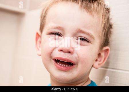 Portrait Of Crying Baby Boy In Home. Stock Photo