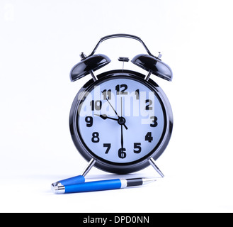 Alram clock on white background with pen Stock Photo