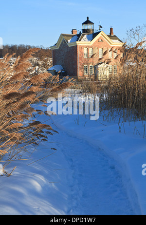 A snow covered path leads to the Saugerties Lighthouse on the Hudson River in New York
