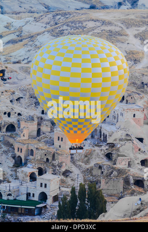 Hot air balloon flying over goreme in cappadocia, turkey Stock Photo