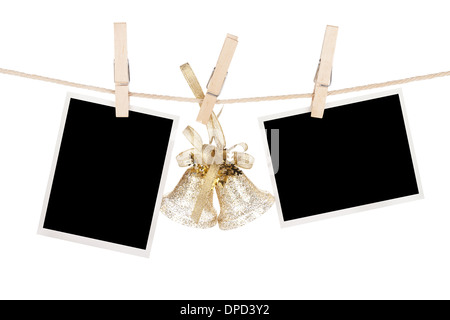 Blank photo frames and christmas decor hanging on the clothesline. Isolated on white background Stock Photo