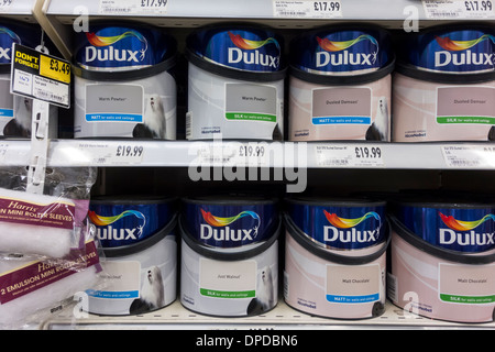 Dulux emulsion paint tins displayed on shelf at Homebase DIY store, UK Stock Photo