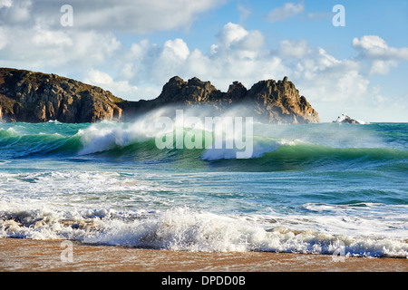 A curling wave breaking at Porthcurno beach, West Cornwall Stock Photo