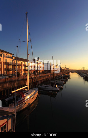 Dawn, boats and houses in Brighton Marina, Brighton & Hove, Sussex County, England, UK Stock Photo