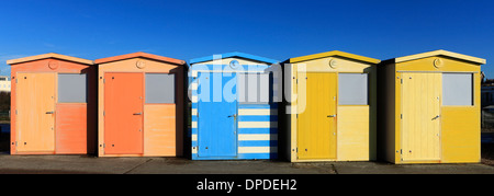 Colourful wooden Beach huts on the promenade, Seaford town, East Sussex, England, UK Stock Photo