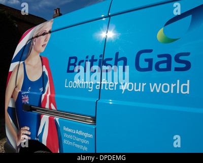 Advertisement featuring Rebecca Adlington wearing a Union Flag on the side of a blue British Gas van parked. Stock Photo