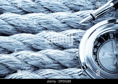 compass with ink pen on ship ropes Stock Photo